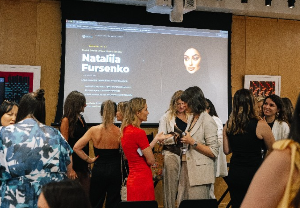 Women in AI forum venue screen with Nataliia Fursenko